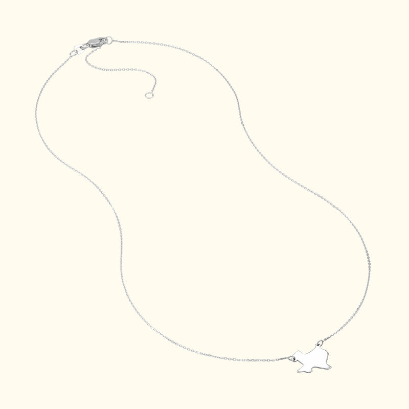 Delicate silver necklace with a small bird pendant.