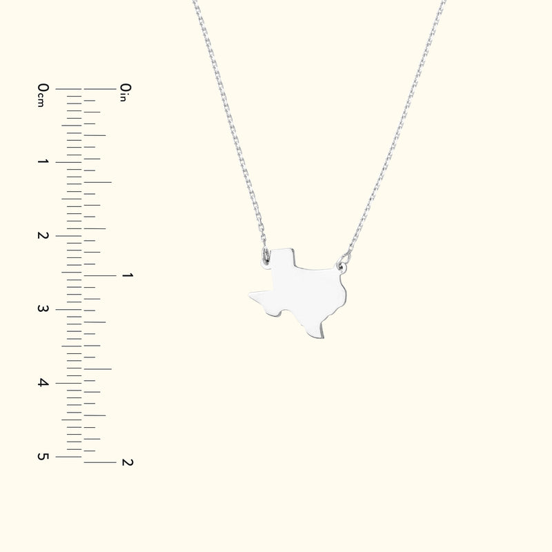 Silver necklace featuring a Texas-shaped pendant, displayed against a light background.