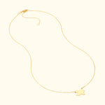 Gold necklace with a delicate chain and a small charm in the shape of a bird.