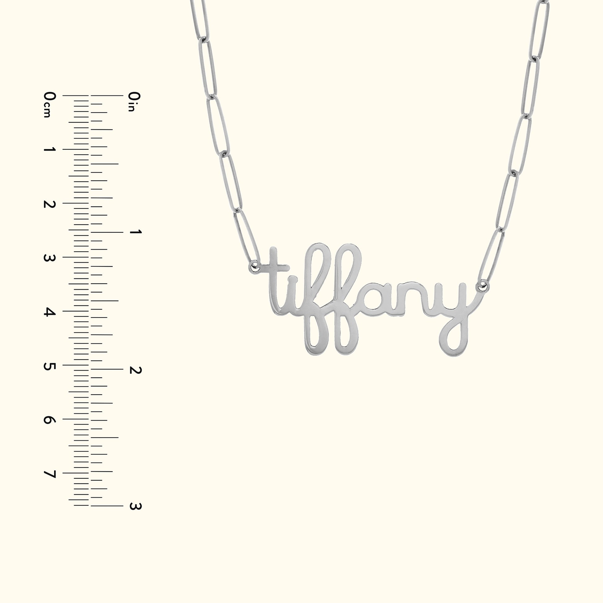 Silver necklace with a cursive "tiffany" pendant and linked chain.