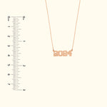 Rose gold necklace featuring the year "2024" as a pendant.