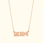 Rose gold necklace featuring the numbers "2024" as a pendant.