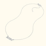 Silver necklace featuring a "2024" pendant on a delicate chain.