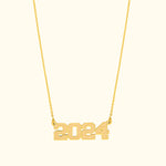 Gold necklace featuring the year "2024" as a pendant.