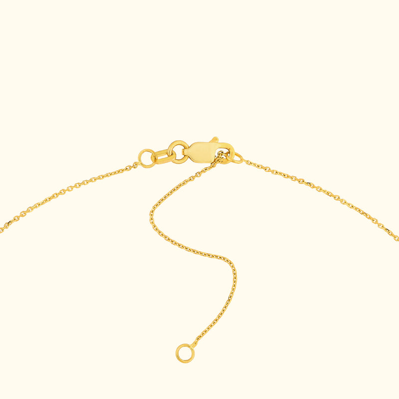 Close-up of a gold necklace clasp with delicate chain links.