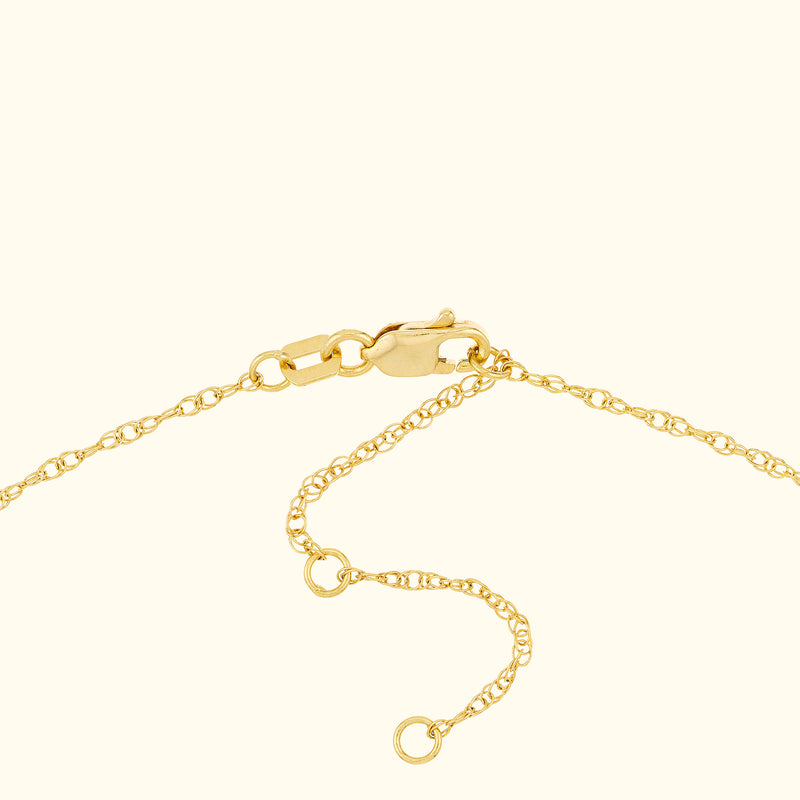 Close-up of a gold chain bracelet clasp with delicate links.