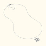 Sterling silver necklace featuring a large number "12" pendant.