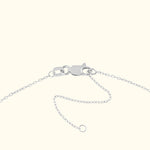 Silver chain bracelet with a clasp and extension links on a light background.