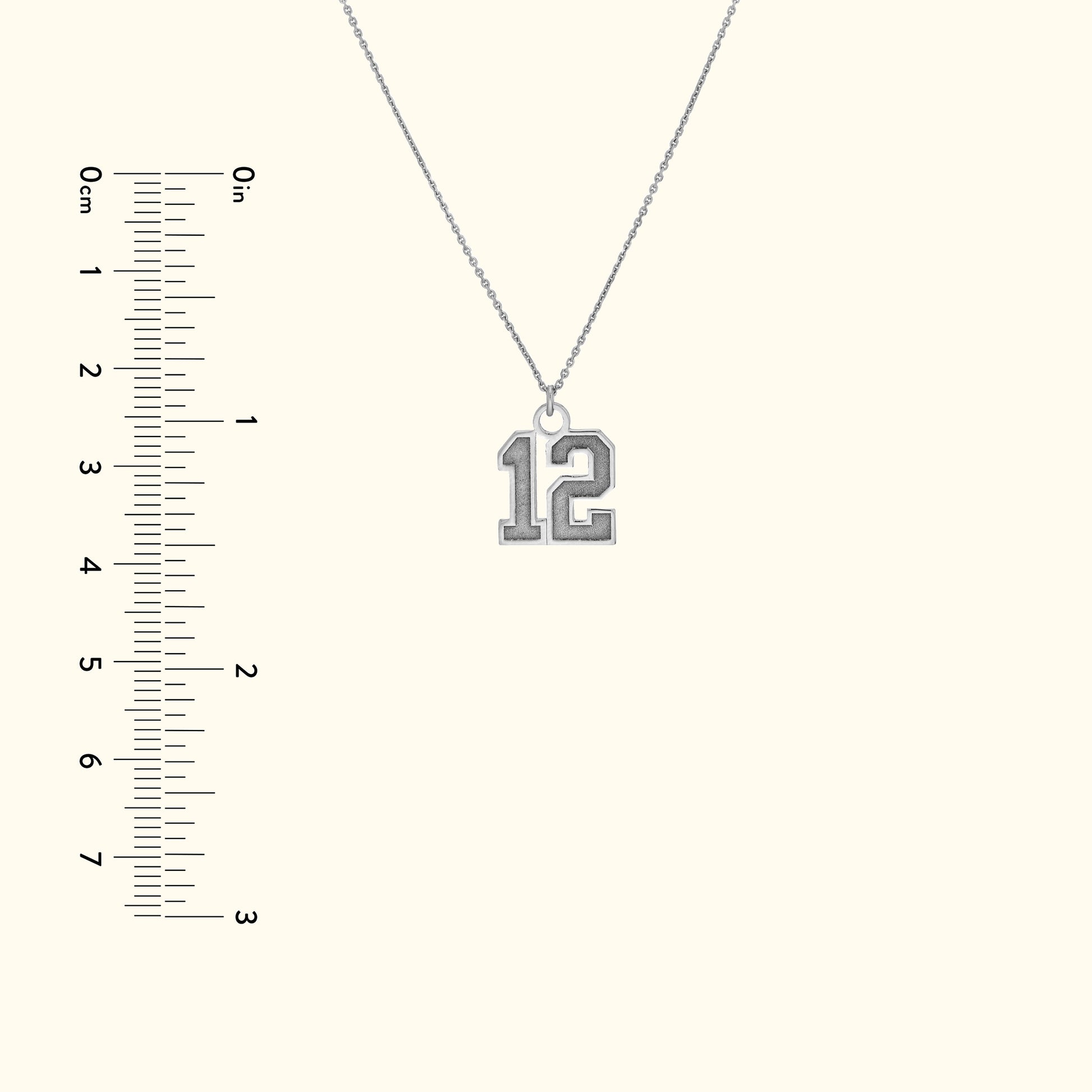 Silver necklace featuring a large pendant shaped like the number 12.