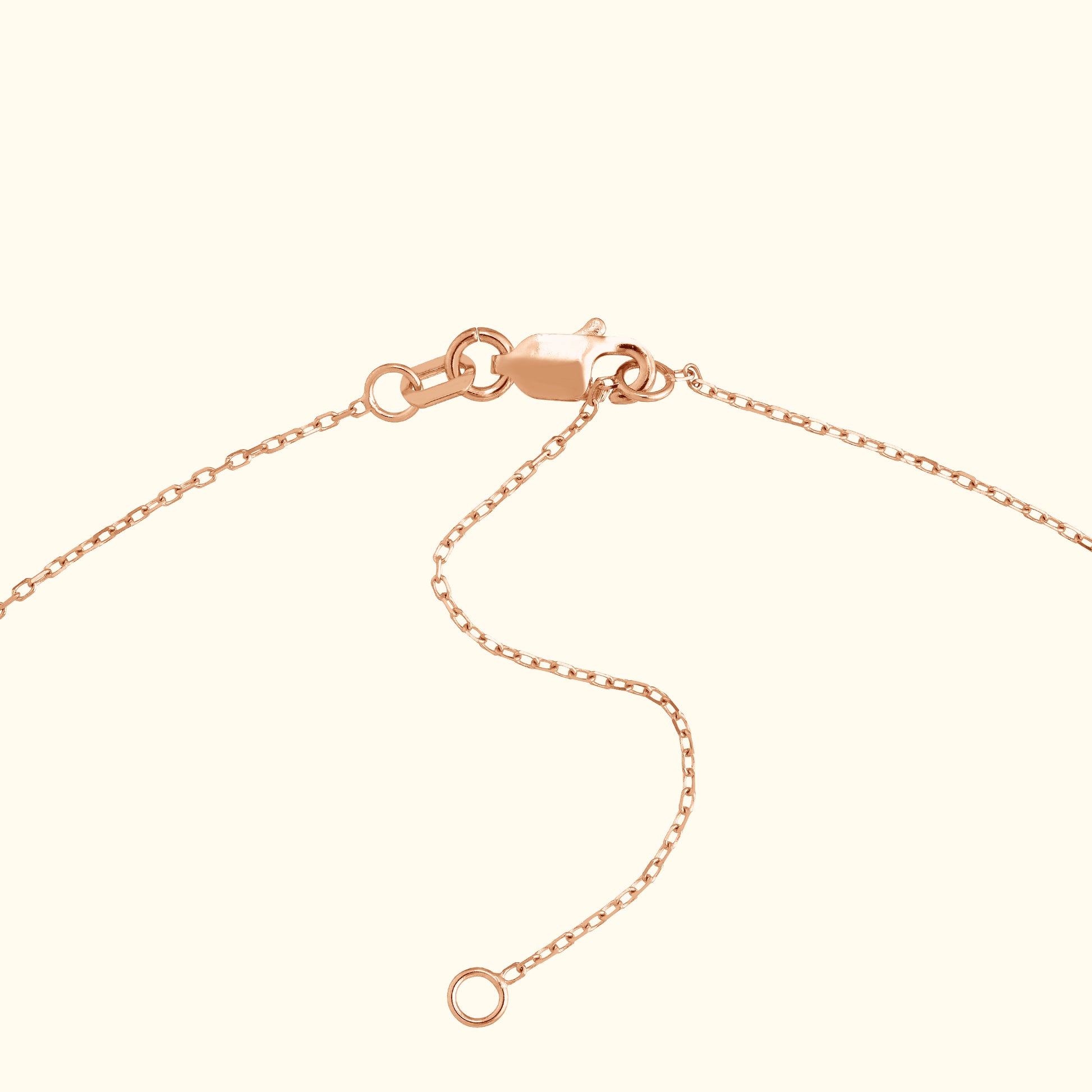 Close-up of a rose gold necklace clasp and chain.