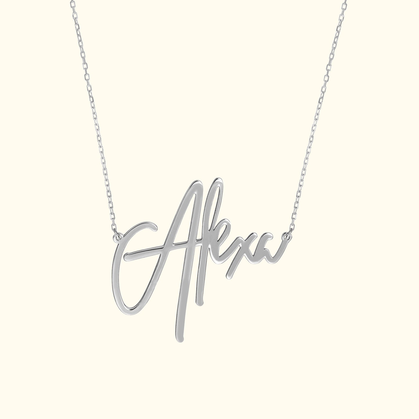 Silver necklace featuring a cursive name pendant "Alexa."