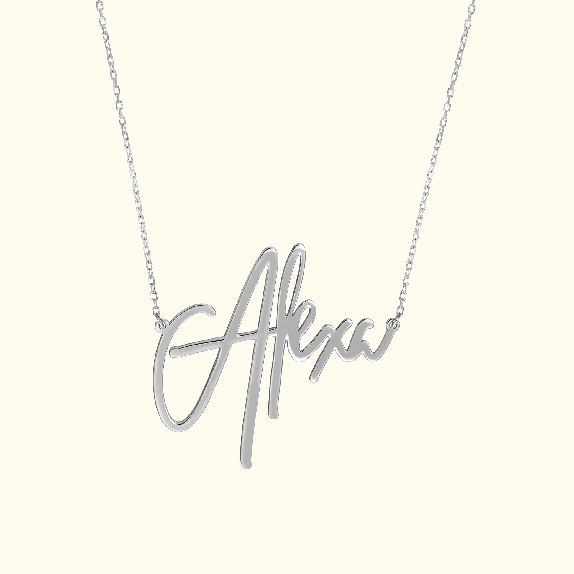 Silver necklace featuring a cursive name pendant "Alexa."