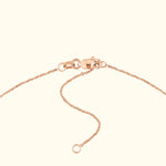 Close-up of a rose gold necklace clasp and chain.