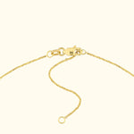Close-up of a gold necklace clasp and chain links.