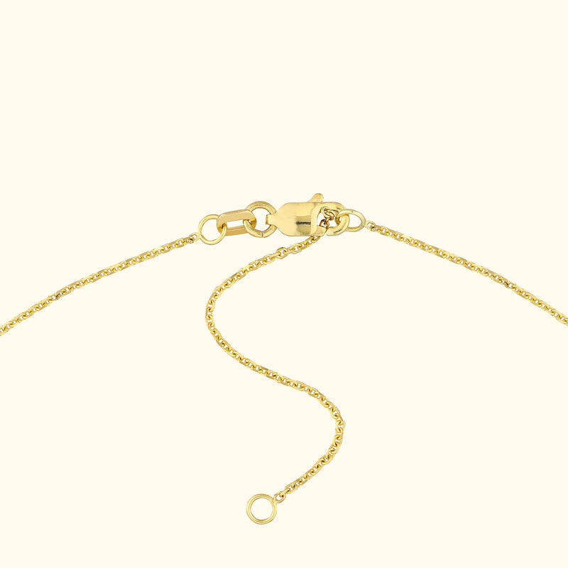 Close-up of a gold necklace clasp and chain links.