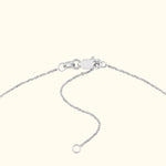 Silver chain necklace clasp with an adjustable length detail.