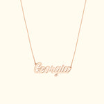 Rose gold name necklace spelling "Georgia" on a delicate chain.