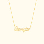 Gold necklace with a cursive name pendant reading "Georgia."