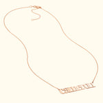 Rose gold name necklace featuring the name "Cameron" in a stylish font.