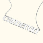 Silver name necklace with the word "cameron" in a stylish font.