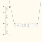 Silver name necklace displaying "Cameron" with a ruler for size reference.