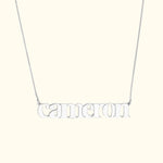 Silver name necklace featuring the word "cameron" in lowercase letters.