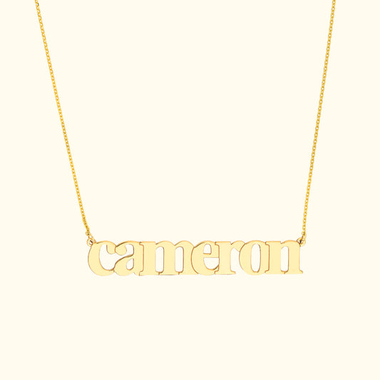 Gold name necklace featuring the word "cameron" in a stylish font.