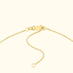 Close-up of a gold chain necklace with a lobster clasp and adjustable length.