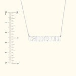 Silver name necklace spelling "Cameron" on a simple chain, with a measuring scale on the side.