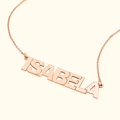 Rose gold name necklace with the name "ISABELA" in bold, capital letters.