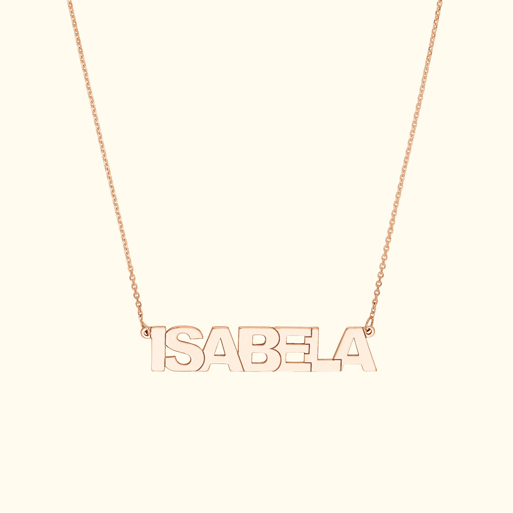 Rose gold name necklace spelling "ISABELA" on a delicate chain.