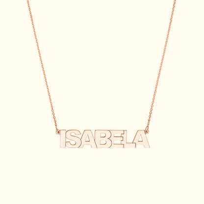 Rose gold name necklace spelling "ISABELA" on a delicate chain.