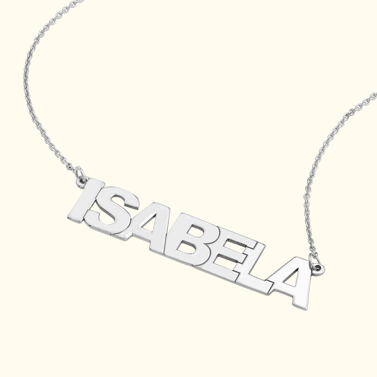 Silver name necklace featuring the name "ISABELA" in bold letters.