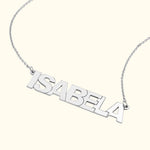 Silver name necklace featuring the name "ISABELA" in bold letters.
