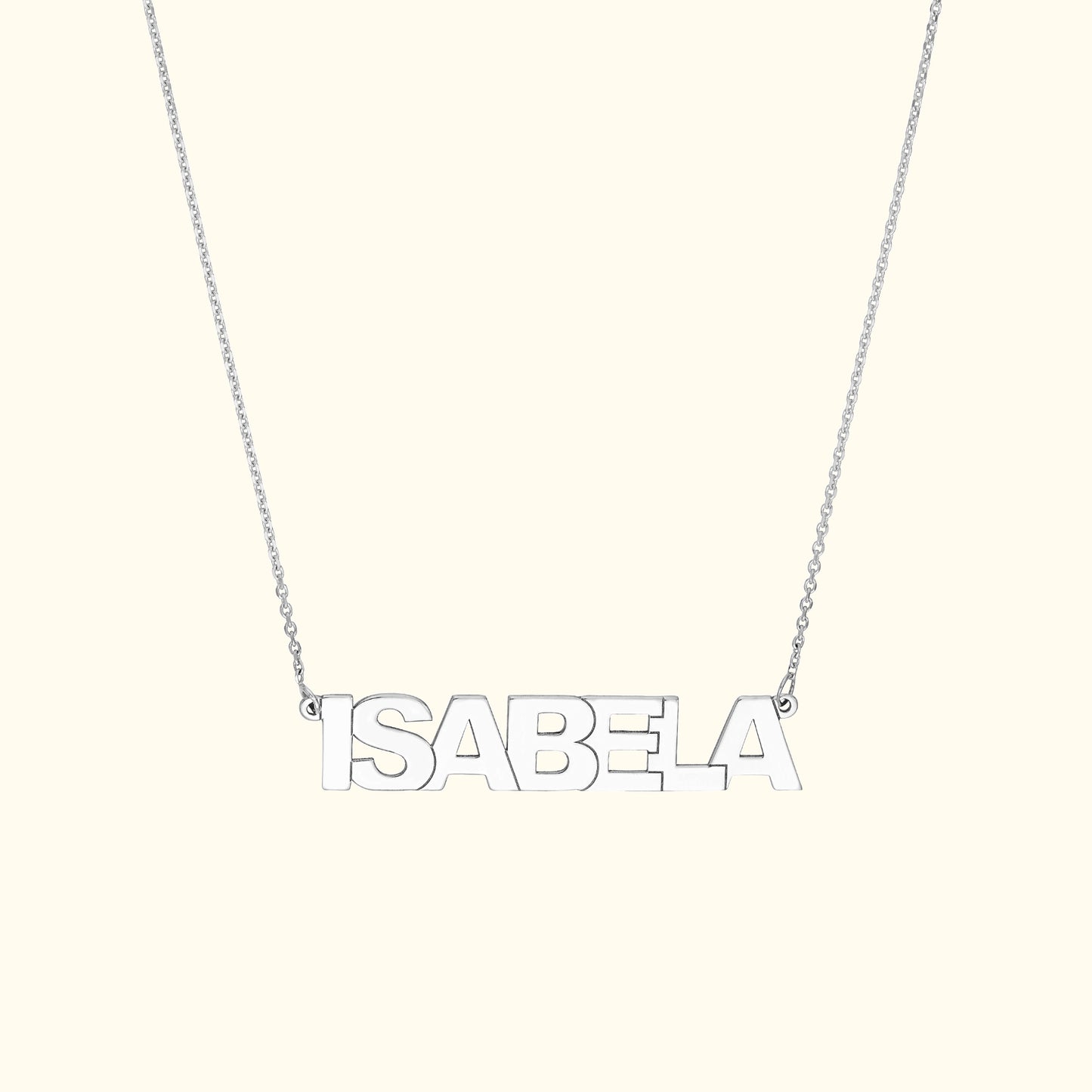 Silver necklace featuring the name "ISABELA" in bold capital letters.