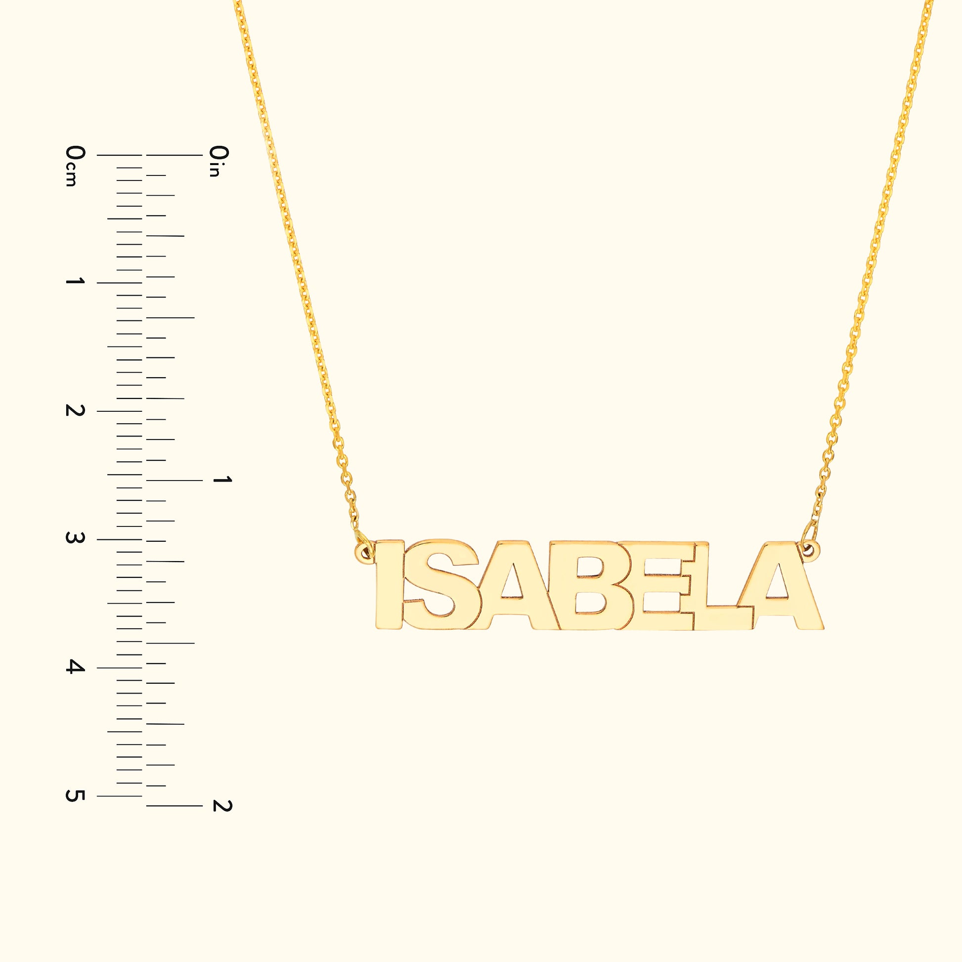 Gold name necklace featuring the name "ISABELA" with a ruler for size reference.