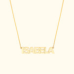 Gold name necklace spelling "ISABELA" on a delicate chain.