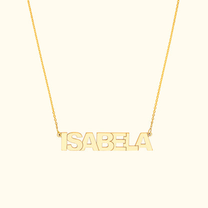 Gold name necklace spelling "ISABELA" on a delicate chain.