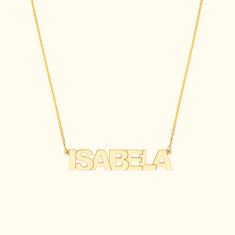 Gold name necklace spelling "ISABELA" on a delicate chain.