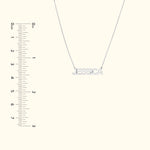 Silver name necklace reading "JESSICA," displayed with a ruler for size reference.