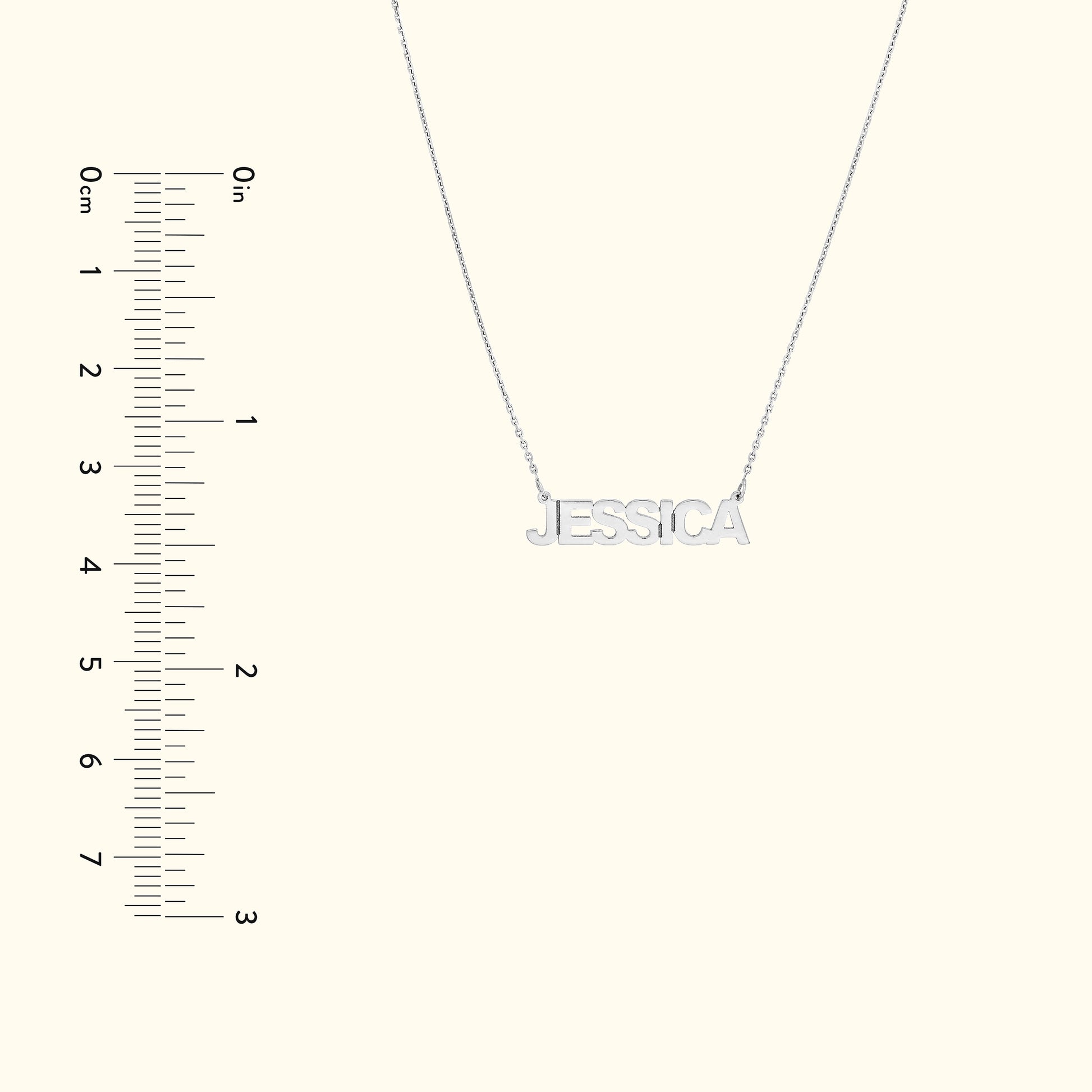 Silver name necklace reading "JESSICA," displayed with a ruler for size reference.