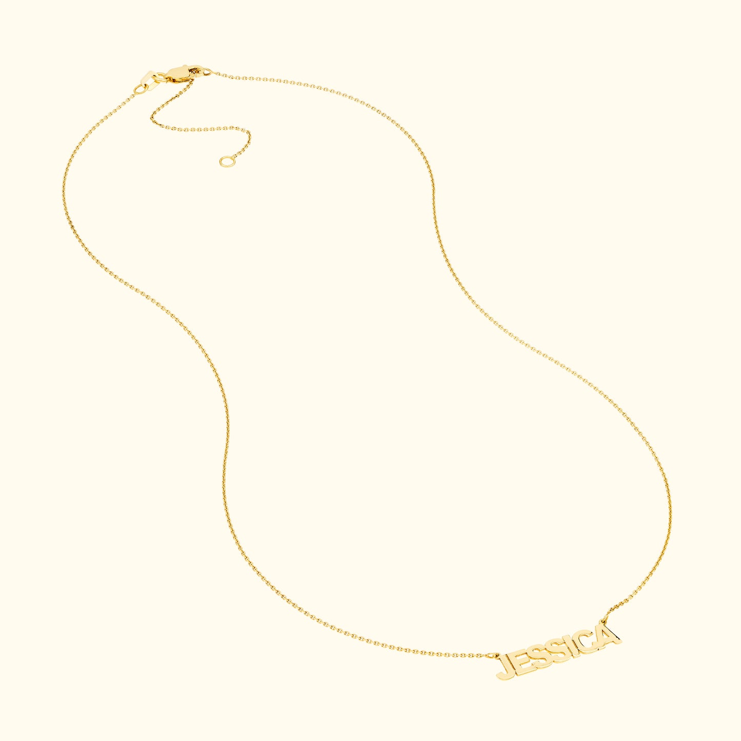 Gold necklace featuring the name "JESSICA" in a stylish font.