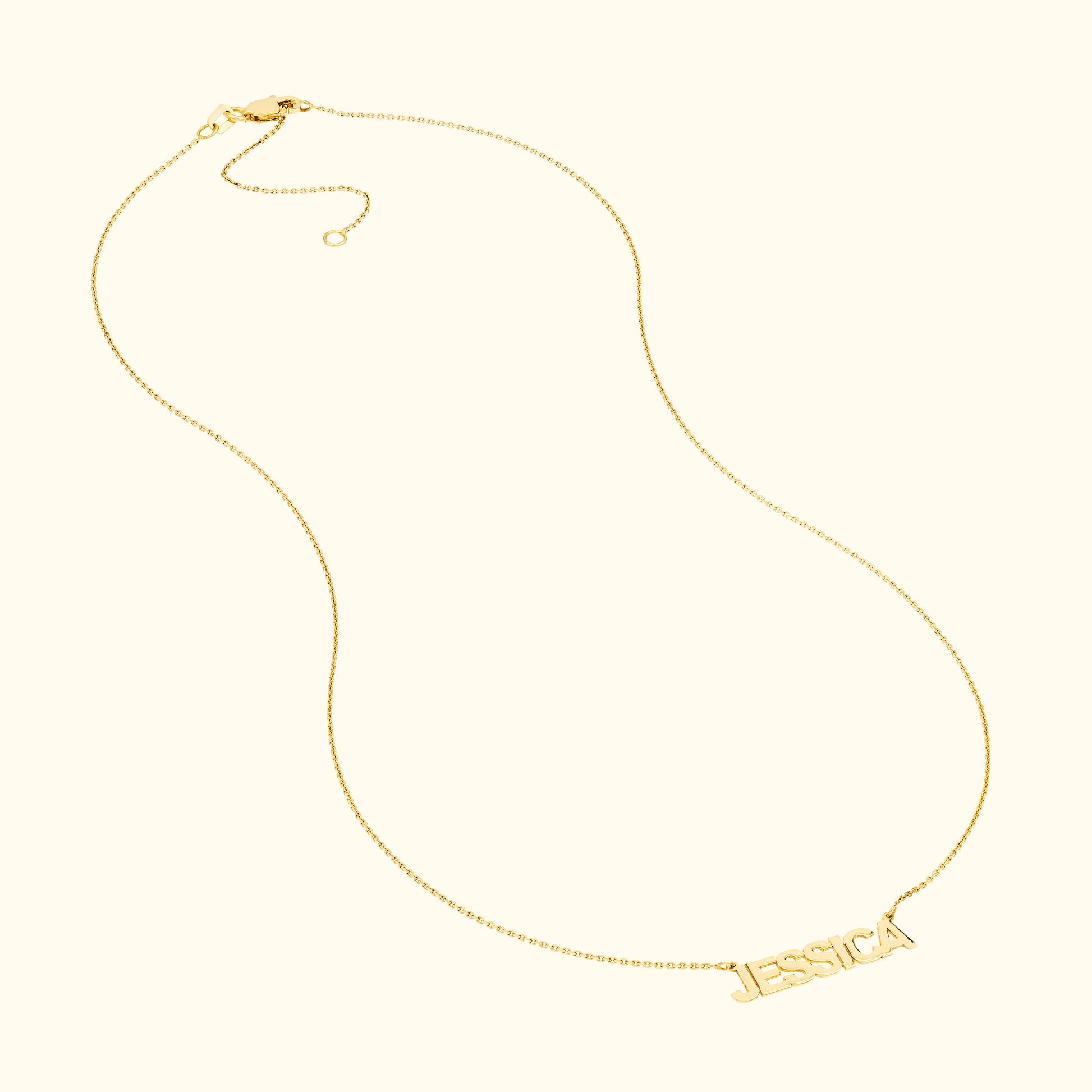 Gold necklace featuring the name "JESSICA" in a stylish font.