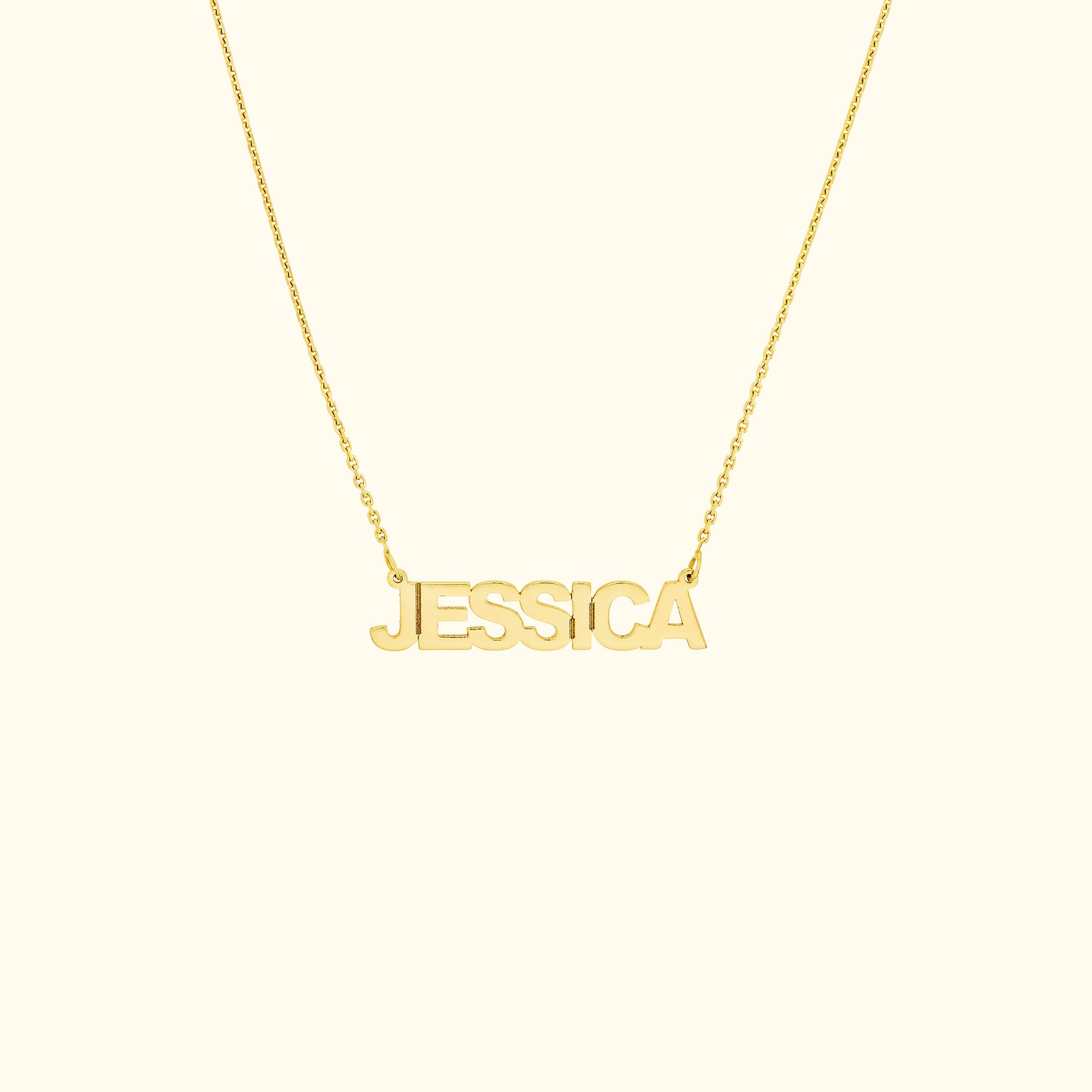 Gold name necklace featuring the name "JESSICA" in bold letters.