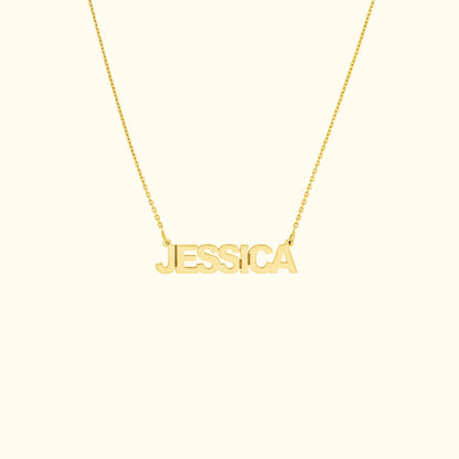 Gold name necklace featuring the name "JESSICA" in bold letters.