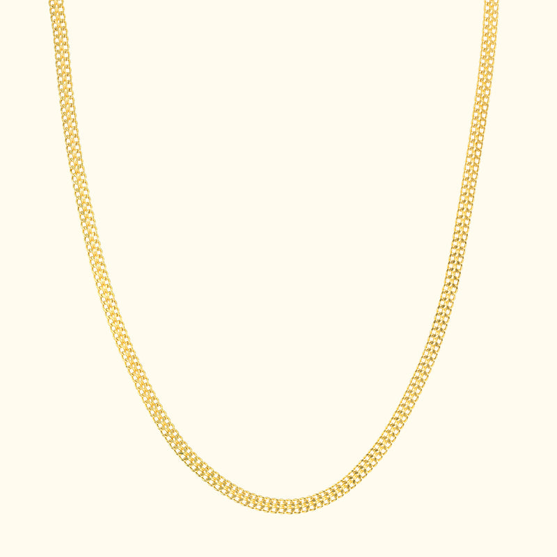 Elegant yellow gold chain necklace on a light background.