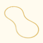 Gold chain necklace with a sleek, curved design on a light background.