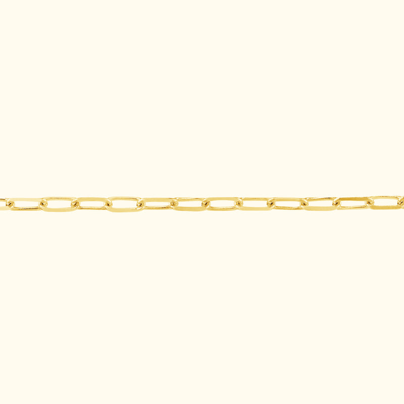 Minimalist gold chain bracelet with oval links against a light background.