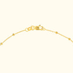 Delicate gold chain bracelet with a clasp, featuring small round embellishments.