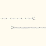 Delicate silver link chain with connection rings on either end, set against a light background.